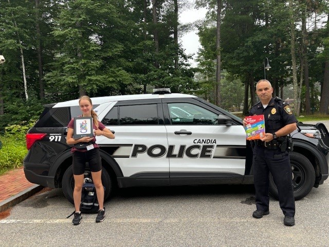 Photo of salesperson, with the Candia police, who is selling books door to door.